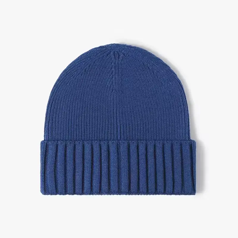 Blue rib-knit fisherman beanie laid flat to show crown and cuff proportions