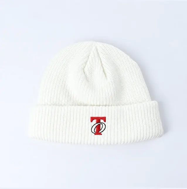 White short fisherman beanie showing vertical rib knit and a small red logo
