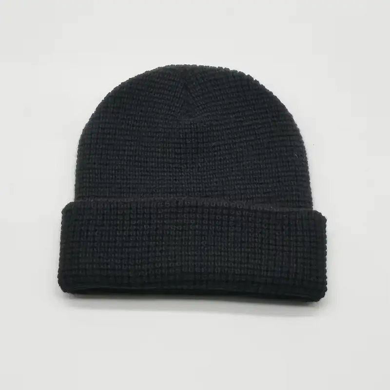 Black waffle-knit short cuffed beanie laid flat