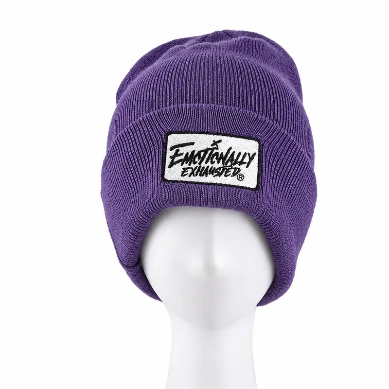 Purple ribbed cuffed beanie on a white display head with an embroidered cuff patch