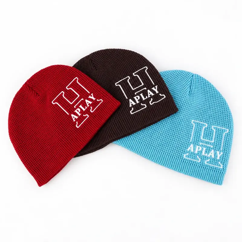Red, charcoal and light blue rib-knit cuffless beanies with APLAY branding, full front views