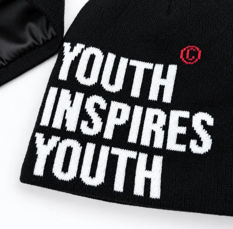 White Youth Inspires Youth lettering on a black rib-knit cuffless beanie body