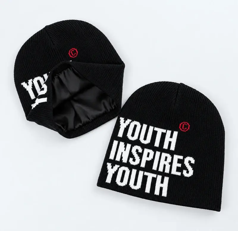 Two black rib-knit cuffless beanies showing white lettering and red logo marks on the body