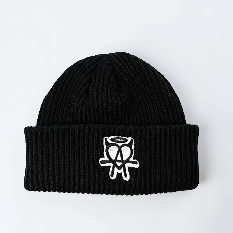 Black ribbed fisherman beanie with white embroidered motif on folded cuff, front view