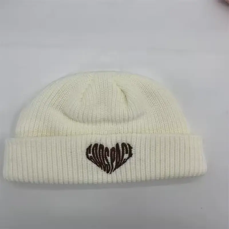 Cream short fisherman beanie with a small embroidered heart motif