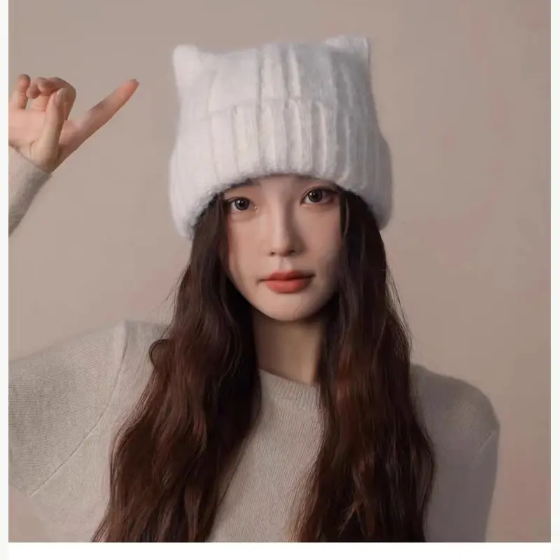 Light gray ribbed slouchy beanie worn by a model