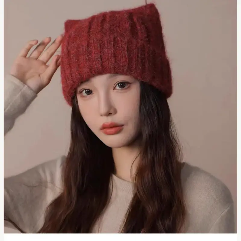 Red ribbed slouchy beanie worn by a model