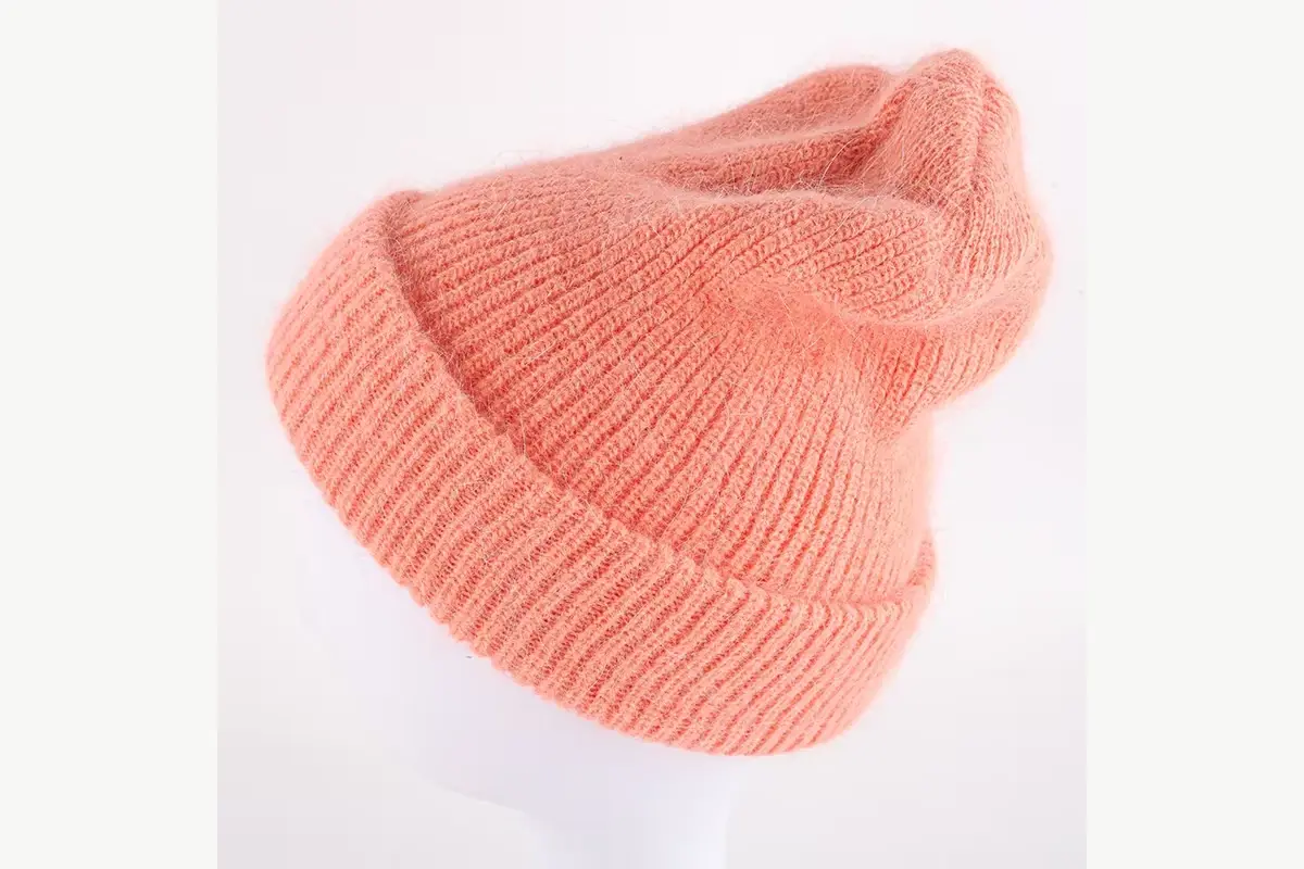Peach ribbed slouchy beanie showing its relaxed rear drape