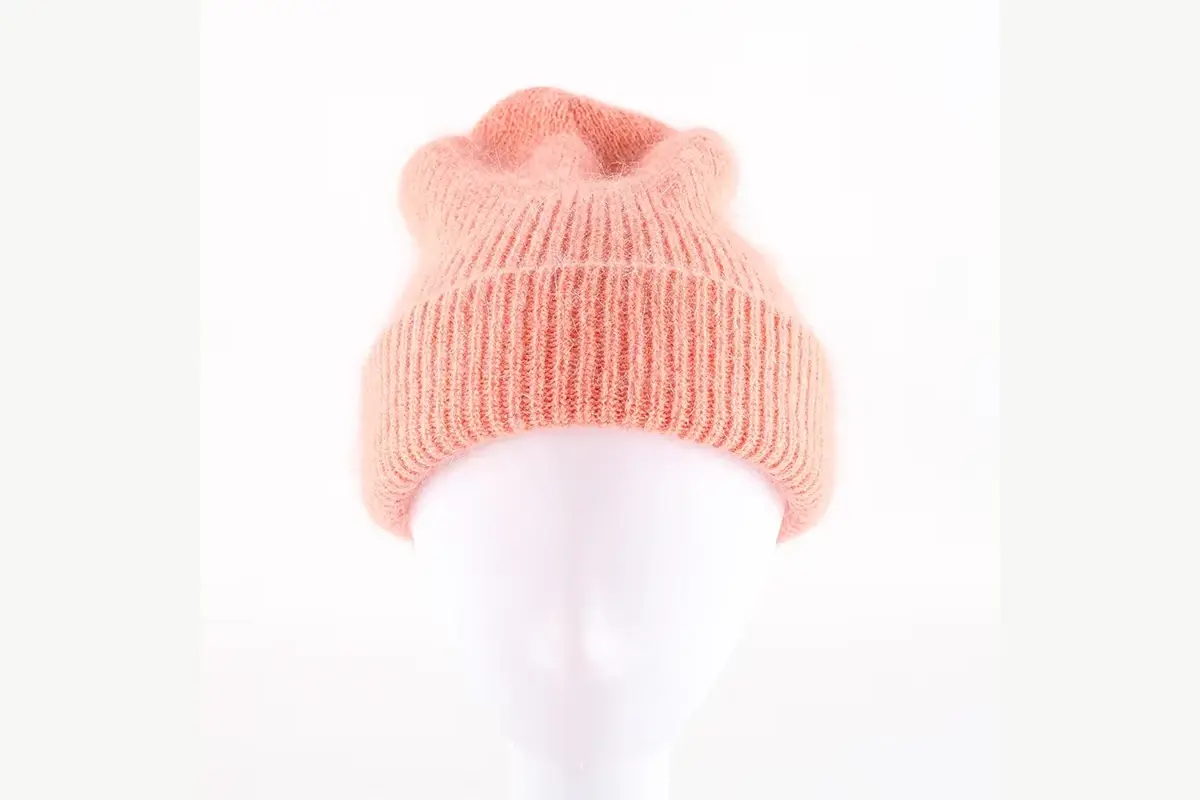 Peach slouchy beanie on a display head showing crown height