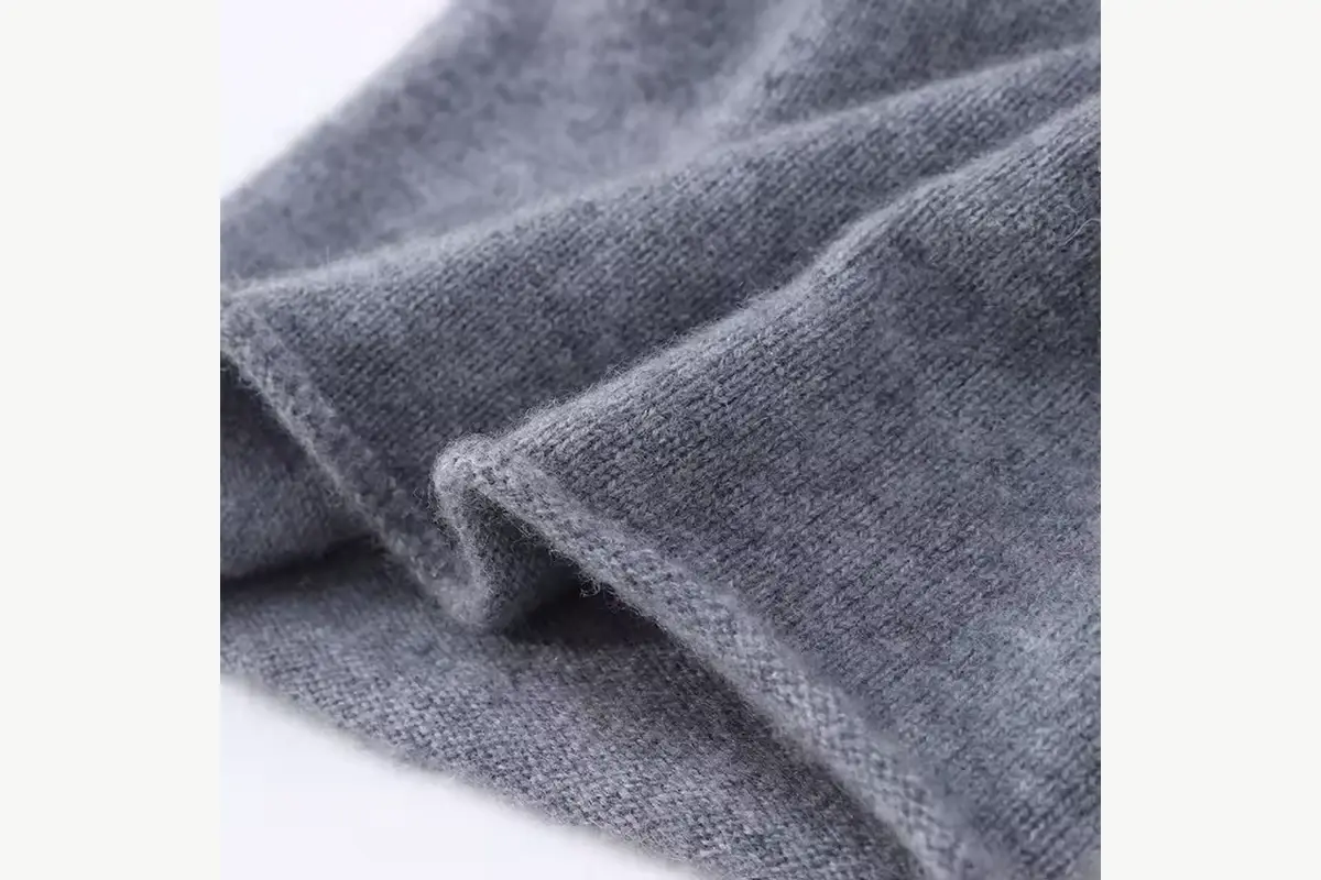 Close view of gray knit fabric showing yarn texture
