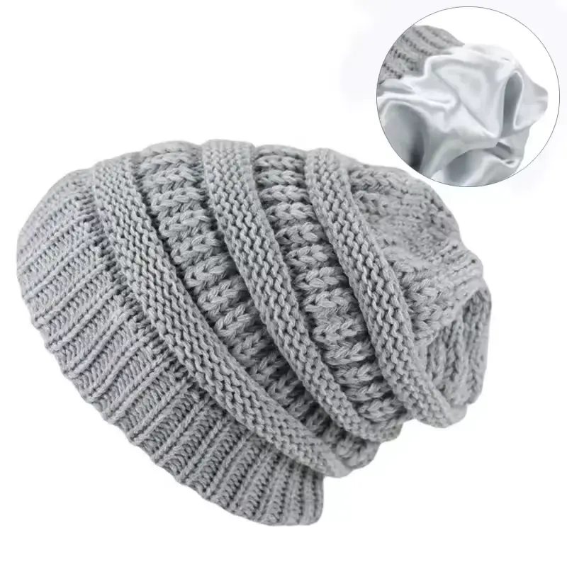 Gray cable knit slouchy beanie shown at an angle