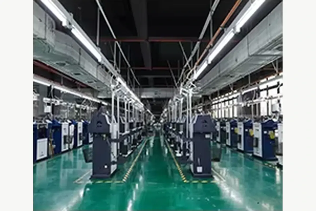 Rows of knitting machines in a textile production workshop