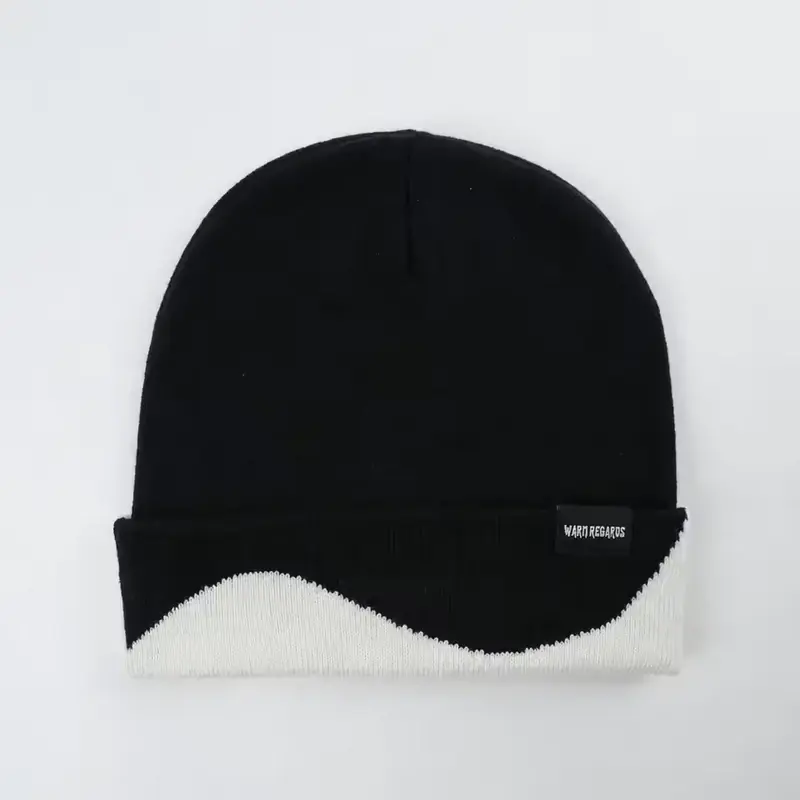 Black low-profile knit cap with a small woven label near the lower edge