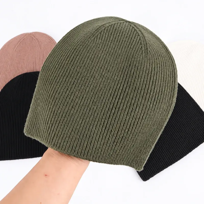 Olive gray ribbed cuffless beanie in front of other ribbed colorways