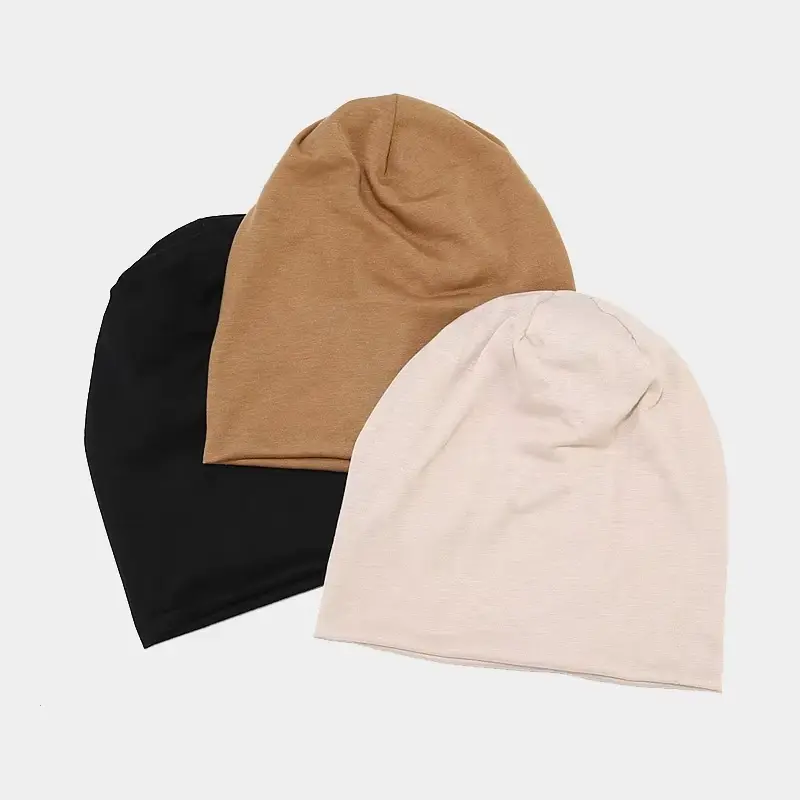 Black, tan and cream cuffless knit beanies shown together