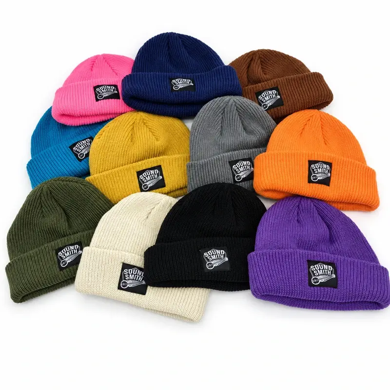 Ribbed cuffed beanies in multiple colors, shown with folded cuffs and patches