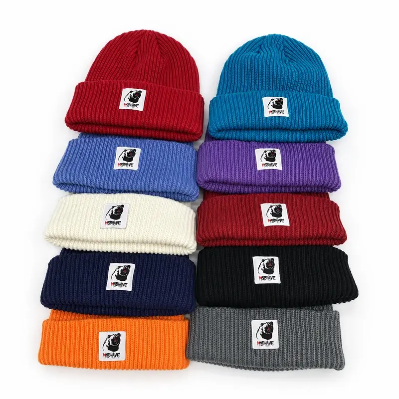 Cuffed beanies in varied colors with small woven front patches