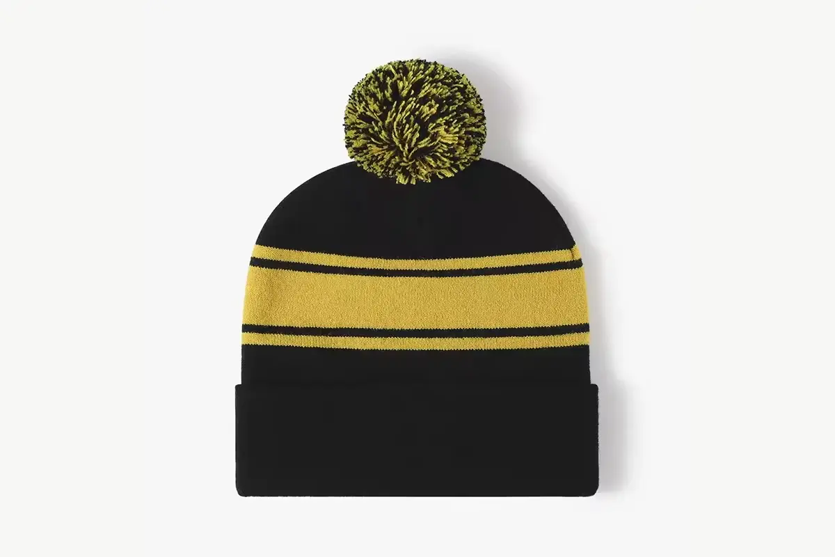 Black and yellow striped beanie with a matching yarn pom