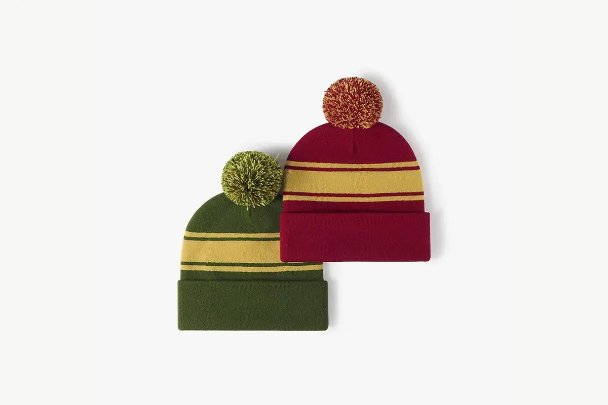 Green and burgundy beanies with contrasting yarn pom colors