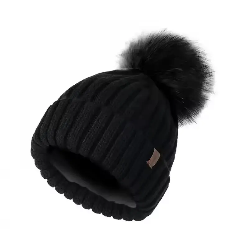 Black rib-knit beanie with a large black faux fur pom