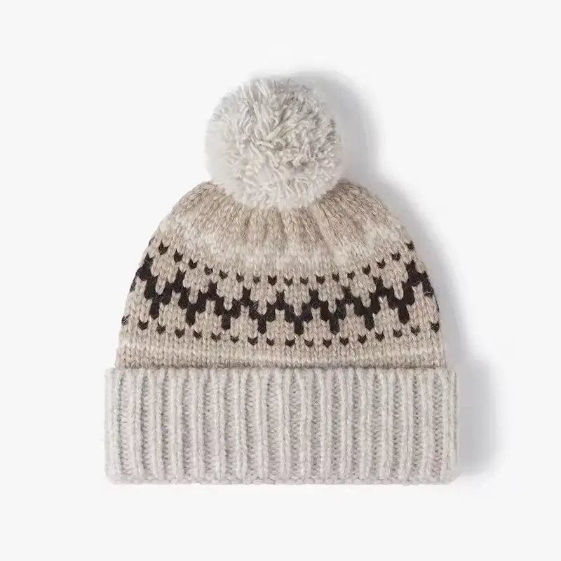 Cream Fair Isle patterned beanie with a yarn pom