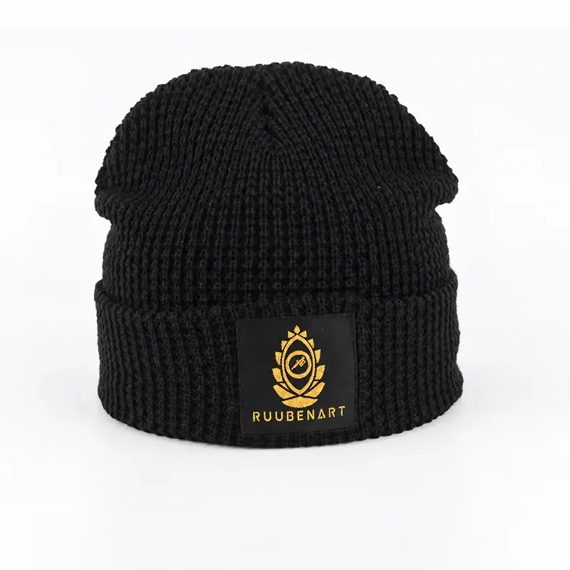 Black ribbed cuffed beanie with vertical knit ribs and a folded cuff