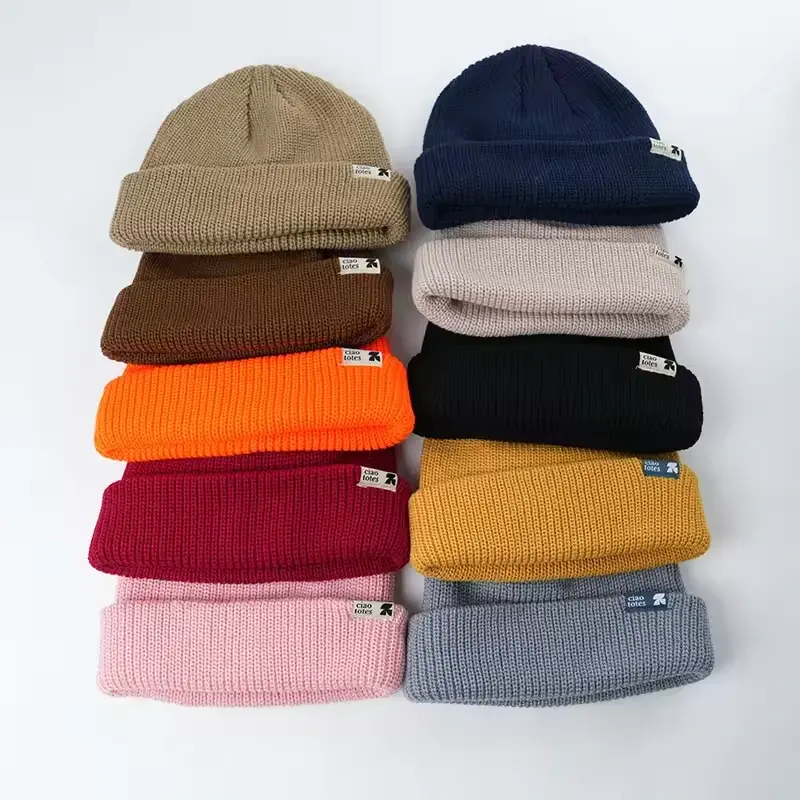 Assorted rib-knit cuffed beanies in neutral and bright colors.
