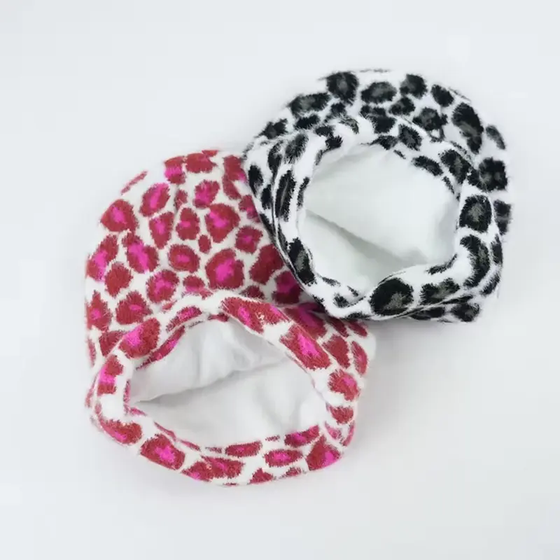 Two patterned cuffed beanies opened to show white fleece lining