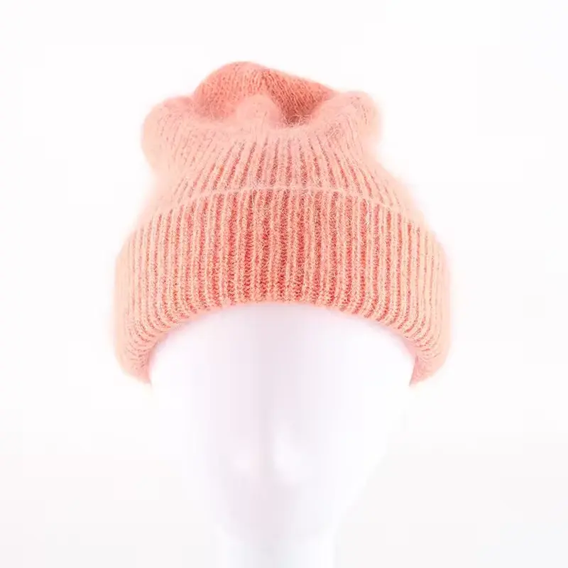 Peach slouchy rib-knit beanie shown on a head form
