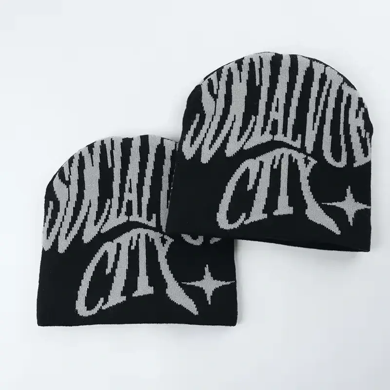 Two black cuffless beanies with white knitted lettering