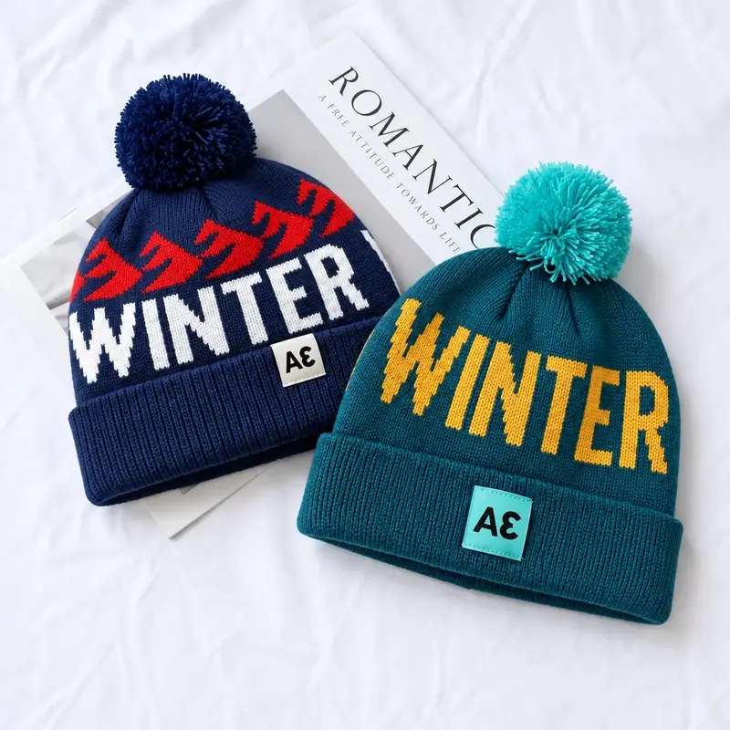 Red and navy Fair Isle winter pom-pom beanies with patterned bands